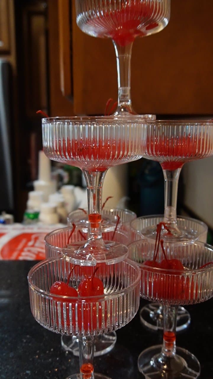 Tiered coupe glass tower of cherry cocktails at a recent event